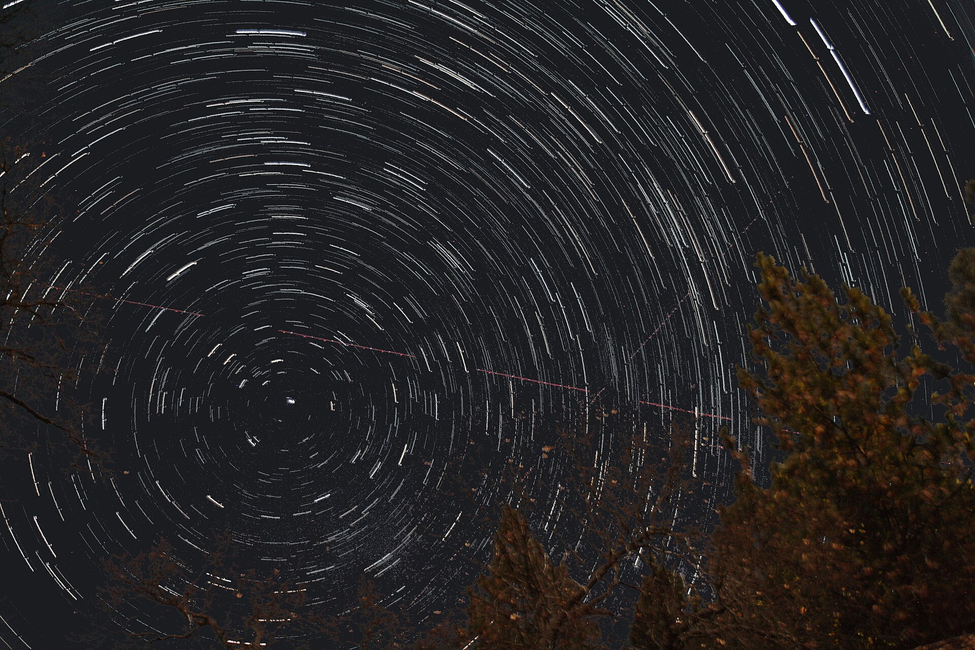 A night sky full of stars appears to rotate around a single star in the center of the image